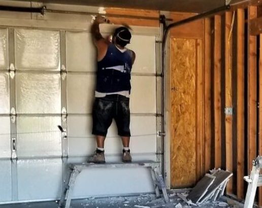 garagedoor-repair work going on by a technician